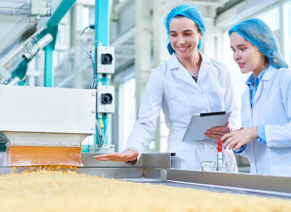 Young Women Working at Food Factory Young Women Working at Food Factory